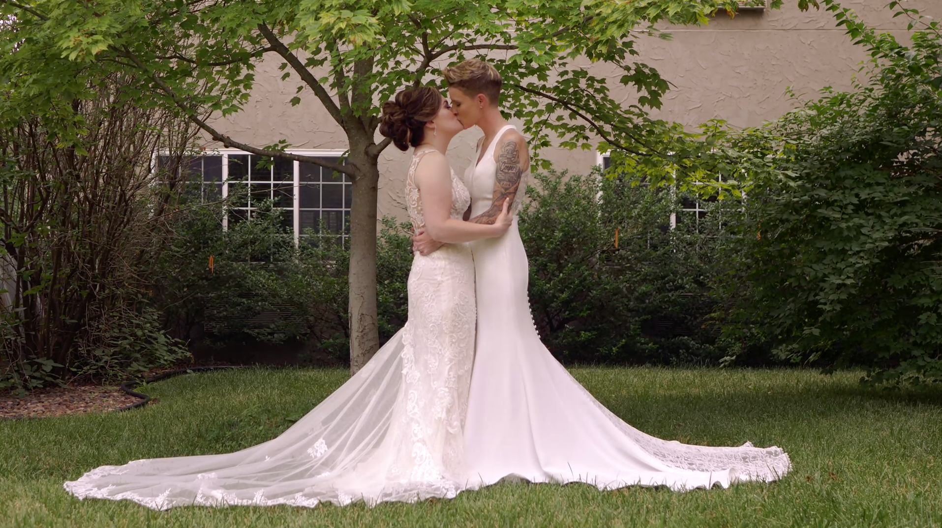 lesbian women kissing before their wedding ceremony
